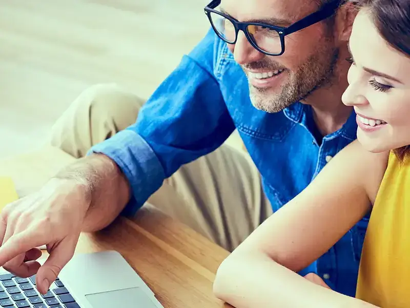 Man and woman shopping on a computer